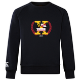 A black Potomac Exiles Rugby Club Club Crew Sweatshirt by Canterbury, from WRS Canterbury, featuring a large embroidered "K" logo on the chest adorned with Maryland and Washington, D.C. flag motifs, a red laurel wreath, "2014," and a small Canterbury logo on the left sleeve. This ultra-soft sweatshirt seamlessly blends distinctive regional pride with premium comfort in every detail.