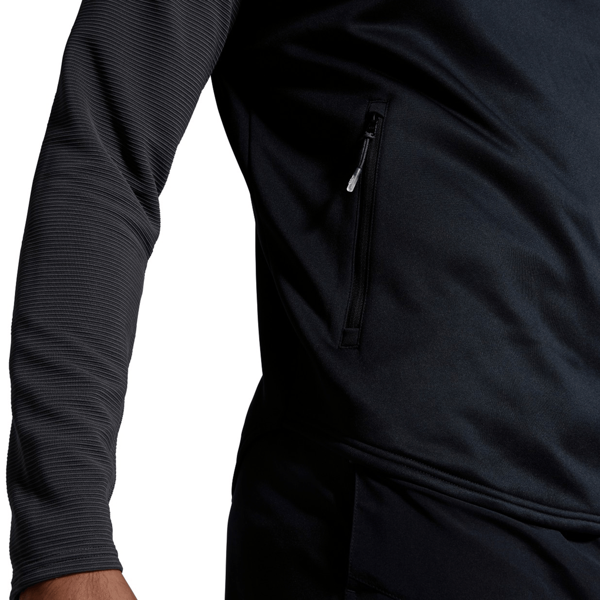 Close-up of a black Canterbury Elite 1/4 Zip Top sports jacket with a zipper pocket on the side.
