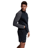 Man in a Canterbury Elite 1/4 Zip Top and shorts looking over his shoulder with a neutral expression.