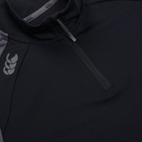 Close-up of a black Canterbury Women's Elite First Layer quarter-zip jacket, featuring VapoDri technology, a subtle shoulder logo, and an intricate honeycomb pattern.