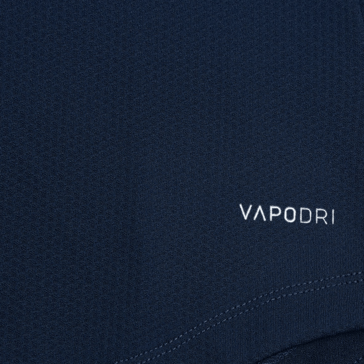 Close-up of the Women's Canterbury Elite First Layer in dark blue, featuring the "VAPODRI" logo and innovative honeycomb fabric design by Canterbury for optimal performance.