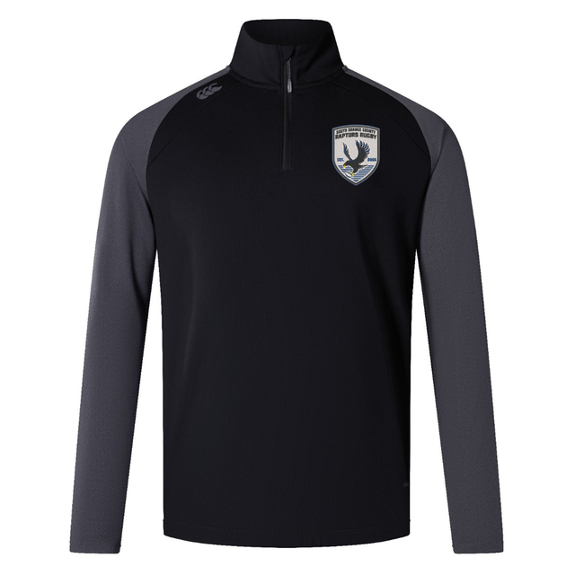 The South Orange County Raptors Elite First Layer by Canterbury is a black and dark gray long-sleeve rugby training top featuring a quarter zip, a crest with a bird emblem on the left chest, and a small Canterbury logo on the right shoulder. Crafted by EMB Canterbury as part of the Canterbury Elite First Layer collection, this pullover incorporates advanced VapoDri technology to keep you cool and comfortable during intense workouts.