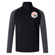 A long-sleeve black and dark gray EMB Canterbury Society of Iowa Rugby Referees Elite First Layer zip-up athletic top, designed with VapoDri technology for enhanced comfort during workouts, featuring a white and pink flower emblem on the left chest.