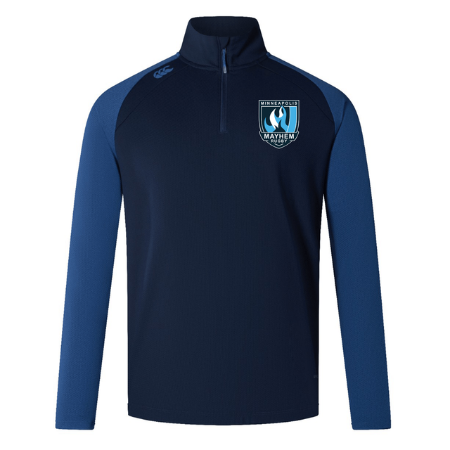 Introducing the Minneapolis Mayhem Rugby Elite First Layer by EMB Canterbury—a navy and blue long-sleeve athletic pullover with a quarter zip. This top features the Minneapolis Mayhem Rugby logo on the chest and the Canterbury logo on the shoulder. Designed for high-performance training, it incorporates VapoDri technology for superior moisture management and comfort during intense sessions.