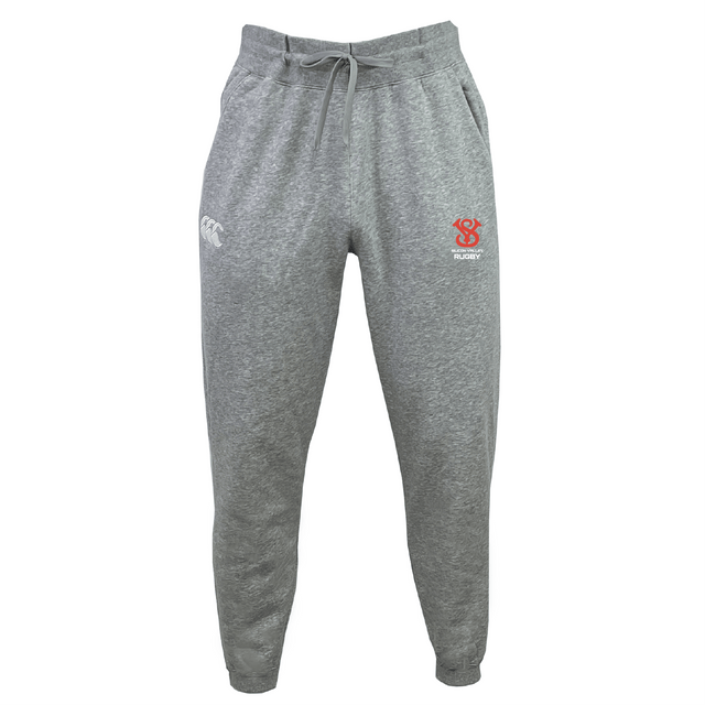 The Silicon Valley Leisure Sweatpant by EMB Canterbury is made from organic cotton and features a drawstring waist. It showcases a white Canterbury logo on the left and a red crest on the right side, delivering both comfort and style.
