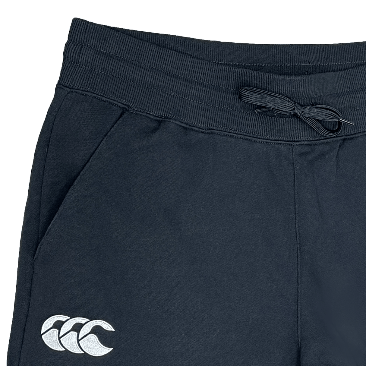Close-up view of Canterbury's black Leisure Sweatpants, crafted from a sustainable blend. Features include an elastic waistband with a drawstring, side pocket, and the Canterbury logo on the left leg.