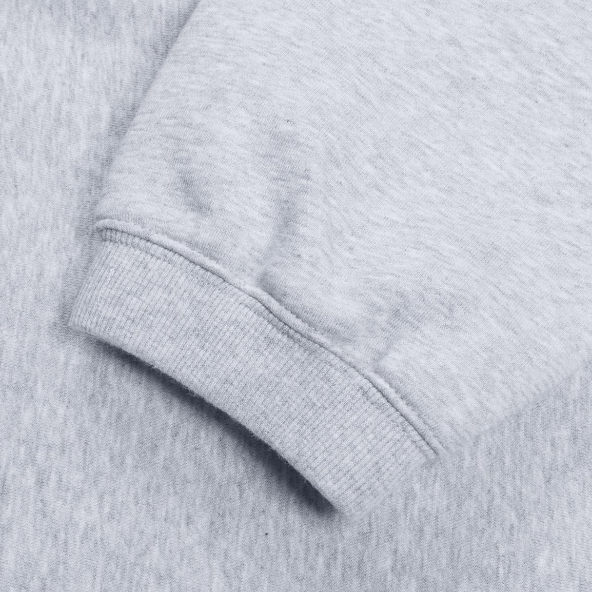 Close-up view of the cuff on a gray Women's Leisure Sweatpant by Canterbury, highlighting the ribbed texture of its cotton blend fleece.