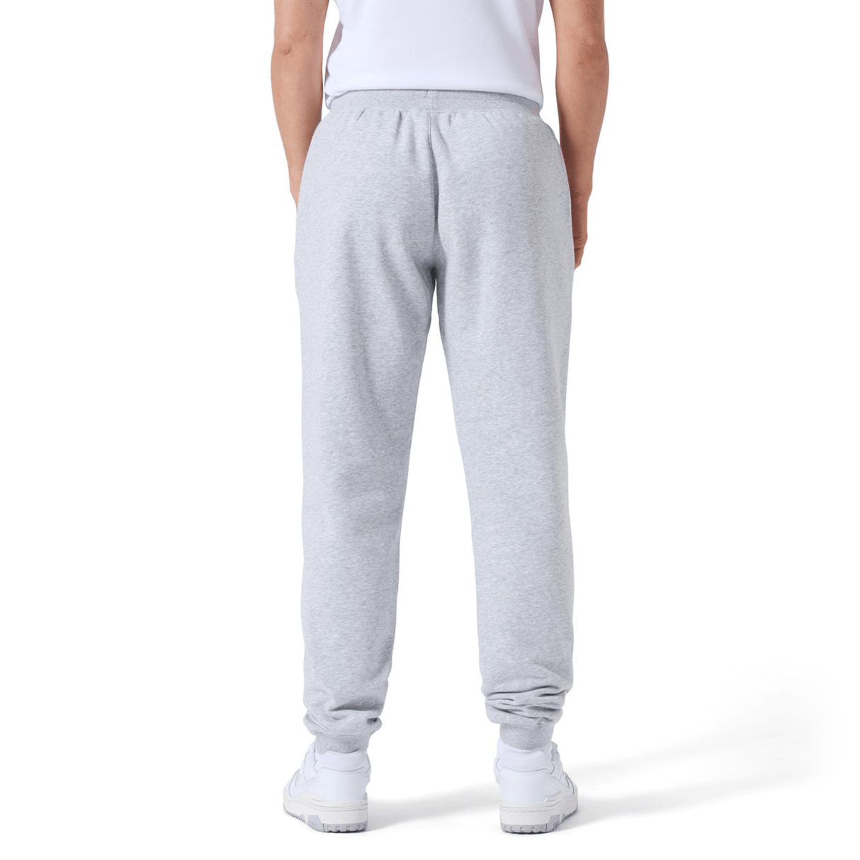 Person wearing gray Women's Leisure Sweatpant by Canterbury and white sneakers, standing with their back to the camera on a plain background. The Canterbury logo is subtly visible, hinting at the premium quality of the cotton blend fleece.