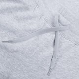 Close-up of the drawstring and waistband of the Women's Leisure Sweatpant by Canterbury in light gray cotton blend fleece, featuring the Canterbury logo.