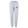 The SF CDME Rugby Women's Leisure Sweatpant by Canterbury from EMB Canterbury features a light gray design with an elastic waistband, drawstring, and a red cross emblem on the left thigh, offering women stylish comfort for everyday wear.