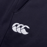 Close-up of a dark fabric with a white Canterbury logo featuring three overlapping curved shapes, crafted from cotton blend fleece on Women's Leisure Sweatpants by Canterbury.
