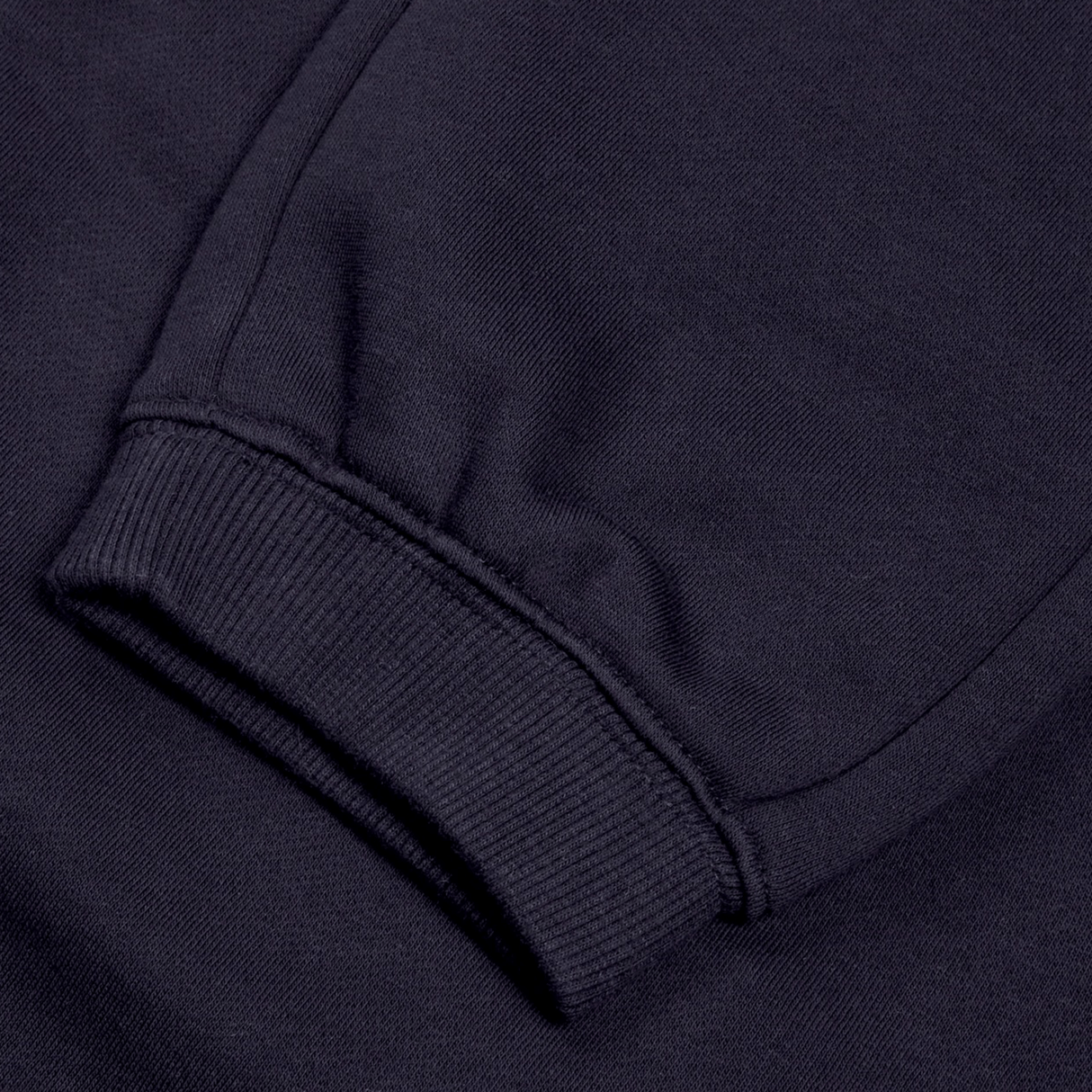 Close-up of a sleeve from Canterbury's Women's Leisure Sweatpant, featuring ribbed cuff detail in a navy blue, cotton blend fleece.