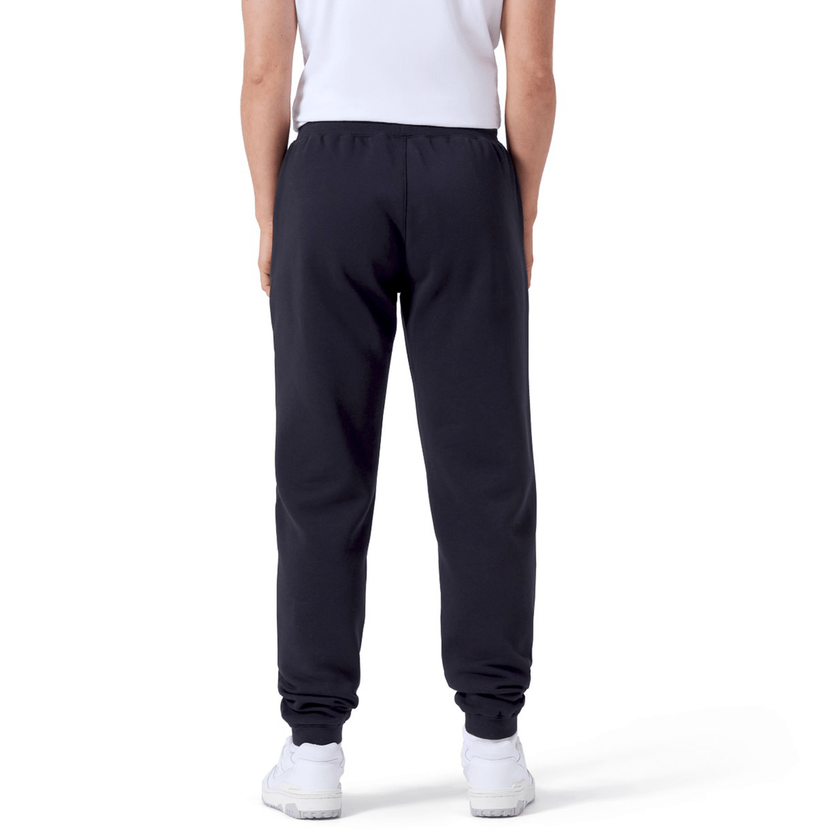 Rear view of a person wearing a white shirt, Women's Leisure Sweatpants by Canterbury, and white sneakers with the Canterbury logo, standing against a white background.