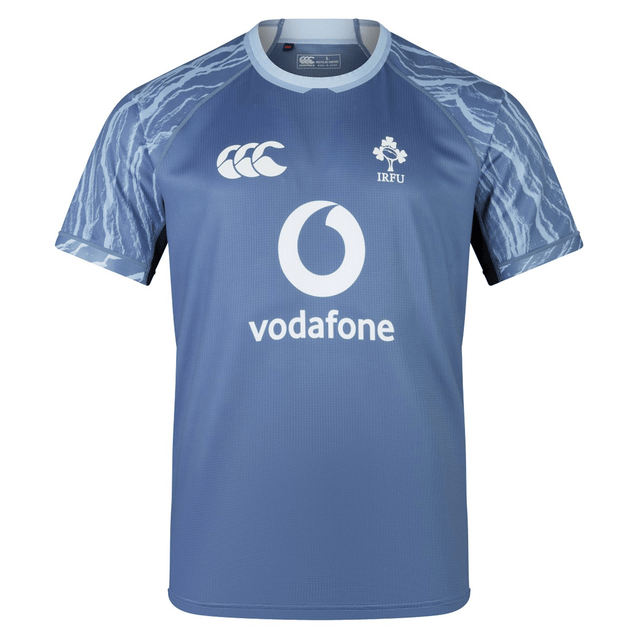 A blue short-sleeve sports training jersey with the IRFU logo and Vodafone sponsorship on the front. The Ireland 24 Training Pro Jersey by Canterbury features shoulders with a pattern resembling lightning.
