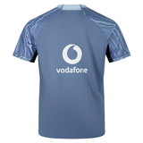A blue Ireland 24 Training Pro Jersey by Canterbury, featuring the Vodafone logo on the back. Crafted by Canterbury, this training jersey combines performance and style seamlessly.