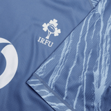 Close-up of the Ireland 24 Training Pro Jersey by Canterbury, a blue sports jersey by Canterbury featuring the IRFU logo and a design resembling tree bark on one sleeve.