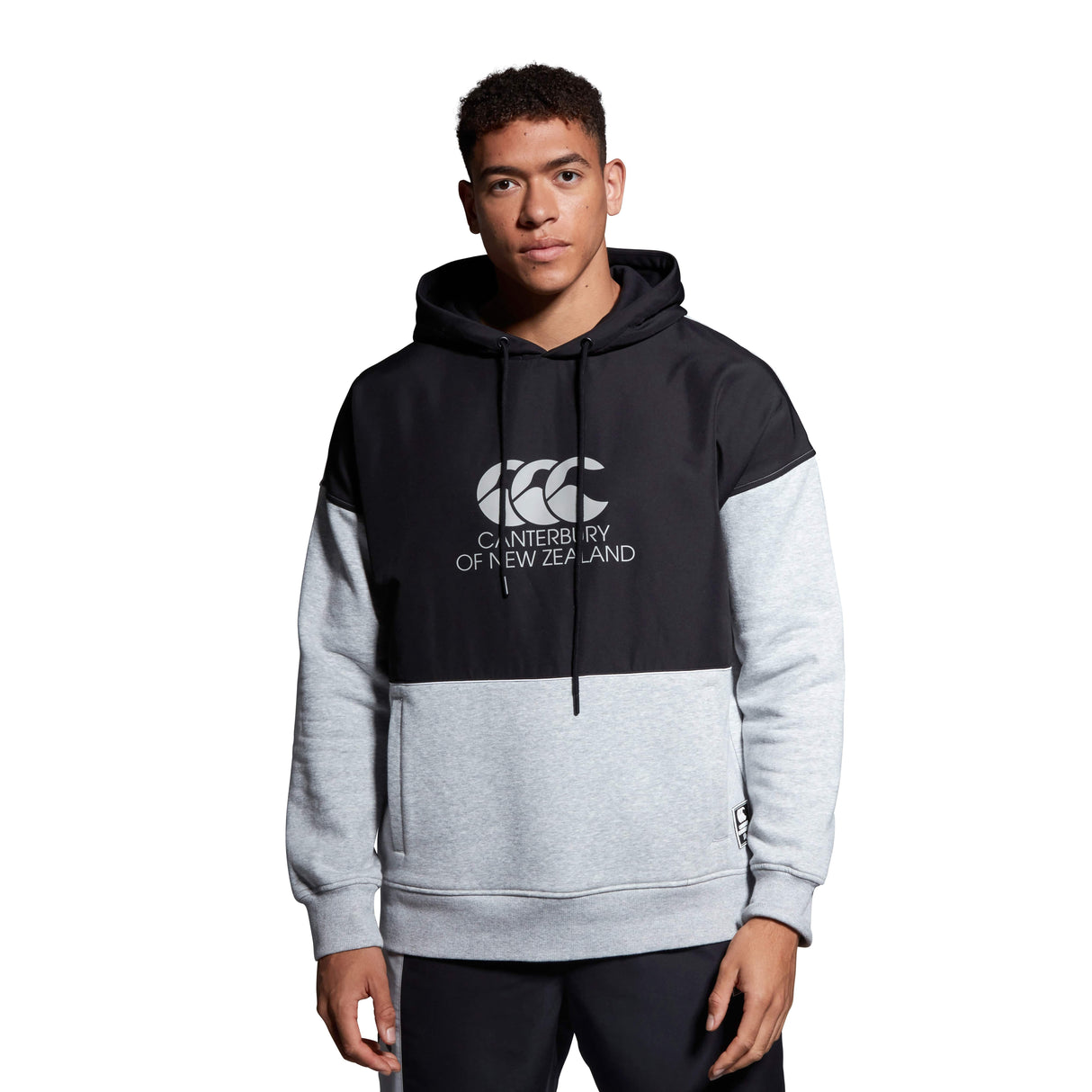 A man wearing a Canterbury Canterbury Legends Panel Hoody.