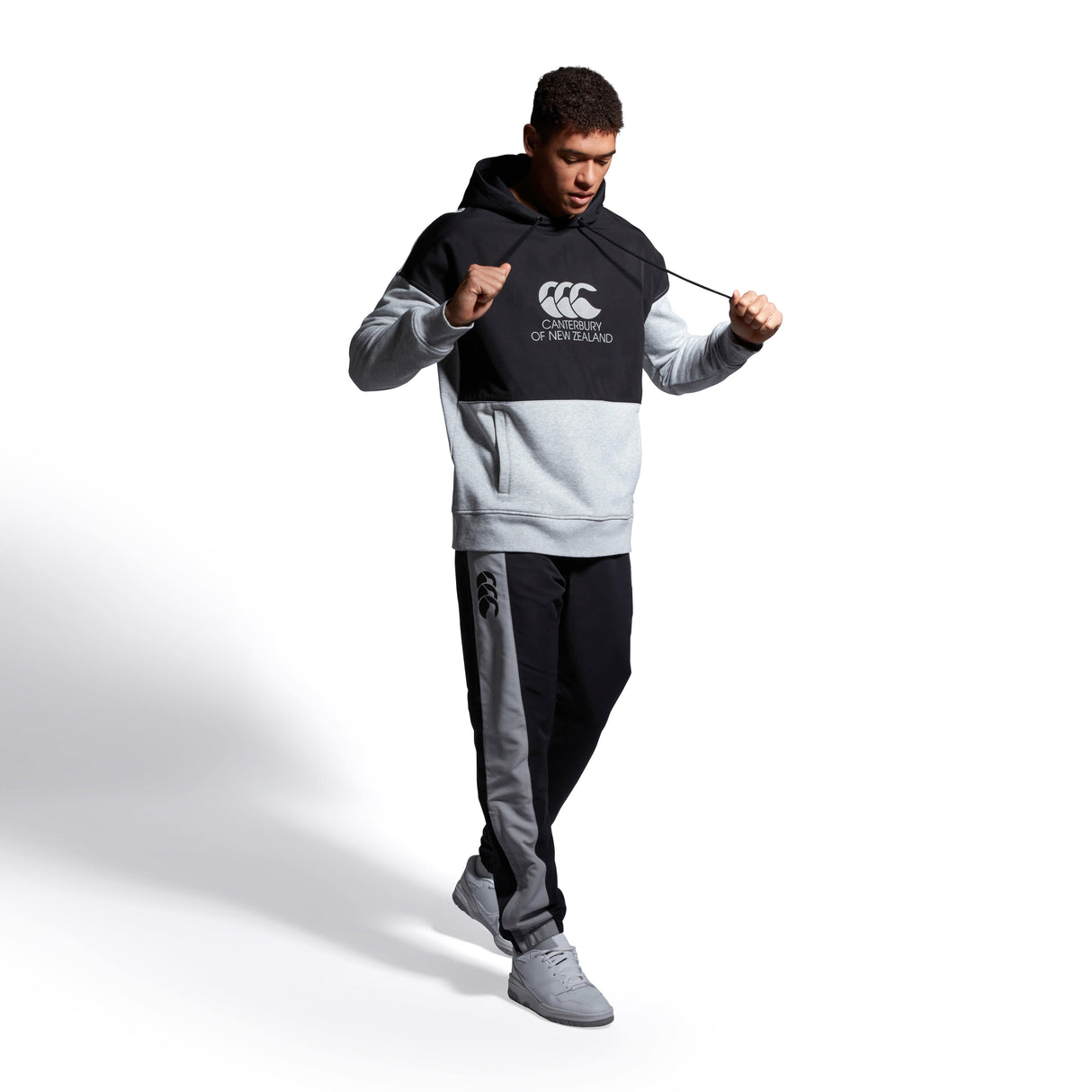 A man in a Canterbury Legends Panel Hoody by Canterbury.
