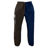 Product Description: Introducing the Canterbury Harlequin Block Stadium Trackpant by Canterbury – a stylish pair of two-tone track pants featuring an elastic waistband and cuffs. The left leg boasts a brown color with a distinctive white CCC logo, while the right leg is in navy blue.