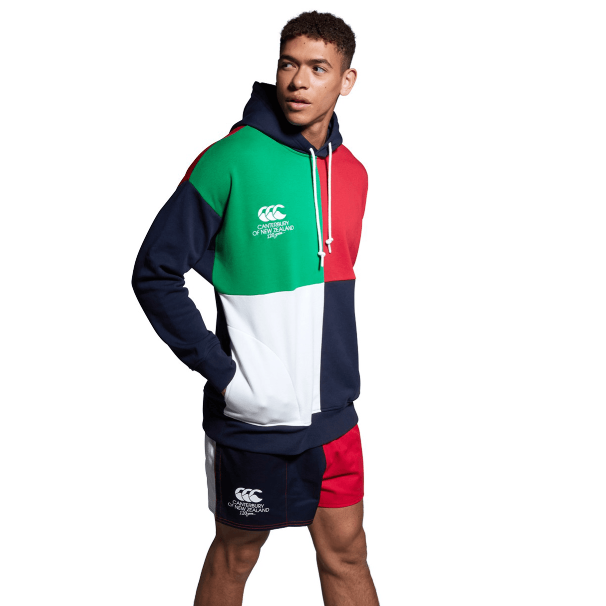 A man wearing a vibrant Canterbury Harlequin hoody and shorts.