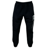 These Canterbury Uglies Stadium Pants from Canterbury feature black track pants with an elastic waistband and cuffs, adorned with a white and blue graphic design on the left thigh. Combining style and comfort, these pants have a tapered leg design.
