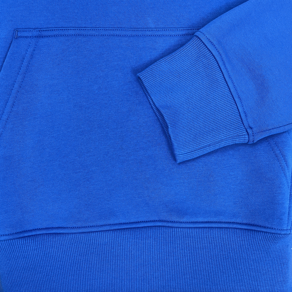 Close-up of the Canterbury Uglies Hoodie in blue, showcasing bold block colors on the sleeve and a stylized CCC logo near the front pocket.