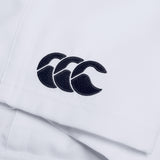 Close-up of a white fabric on the Canterbury Player's Drill Short, featuring a black embroidered logo consisting of three overlapping curves.