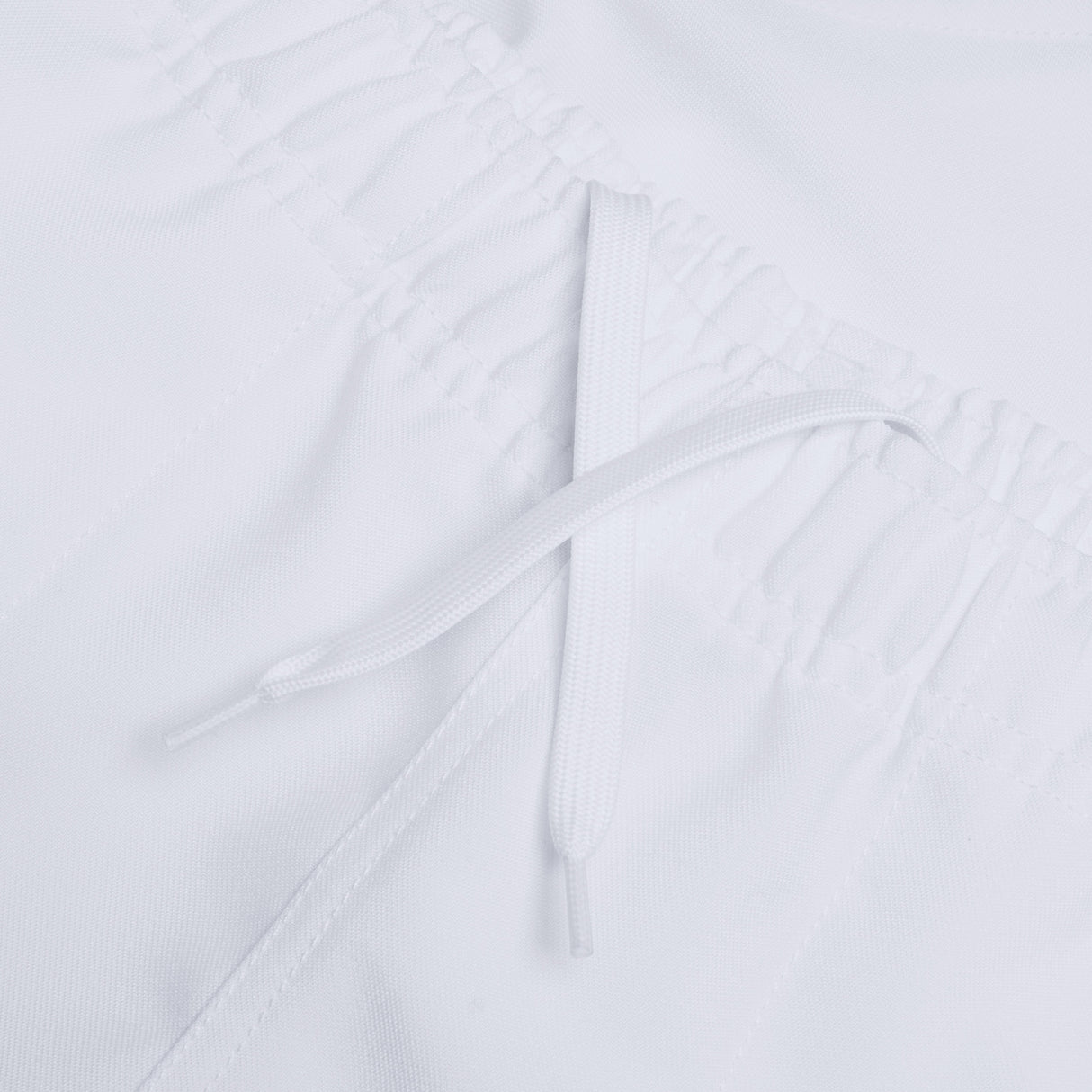 Close-up of the white elastic waistband with an adjustable drawstring, featured on our Canterbury Player's Drill Short by Canterbury.