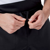 Close-up of hands tying the drawstring on a pair of black Canterbury Player's Drill Shorts. The image focuses on the drawstring and the hands, highlighting the quality and design of these sustainable athletic shorts by Canterbury.