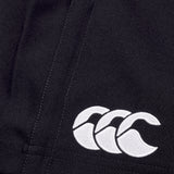 Close-up of a Canterbury Player's Drill Short in black, featuring a white embroidered logo of three interlocking crescent shapes, crafted from recycled fabric for sustainable athletic performance.