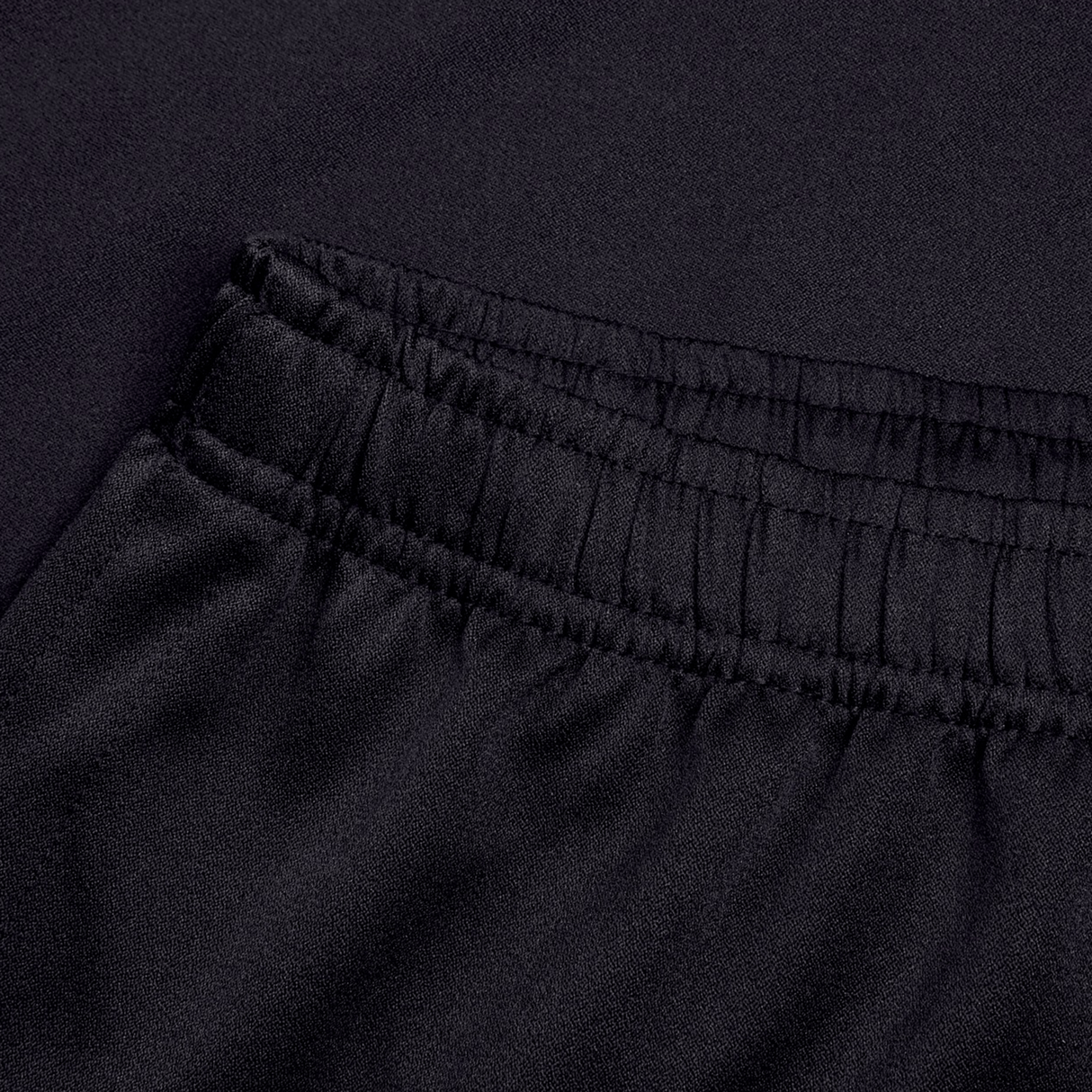 Close-up of the waistband and upper section of Canterbury's Professional Short 2.0, showing gathered elastic for adjustable fit and smooth black fabric.