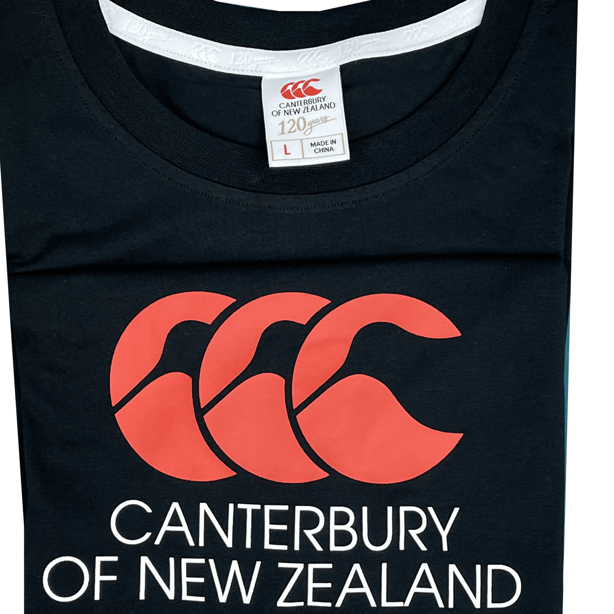 A folded black Canterbury of New Zealand Logo T-Shirt by Canterbury features a striking red CCC Canterbury logo with the text "Canterbury of New Zealand" on the front. The clothing label indicates size "Large" and "Made in China".
