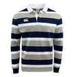 The Canterbury CCC Stripe Long Sleeve Rugger is a stylish rugby shirt featuring thick horizontal stripes in navy blue, beige, and white. It is designed with a white collar and includes a small logo on the left chest area.