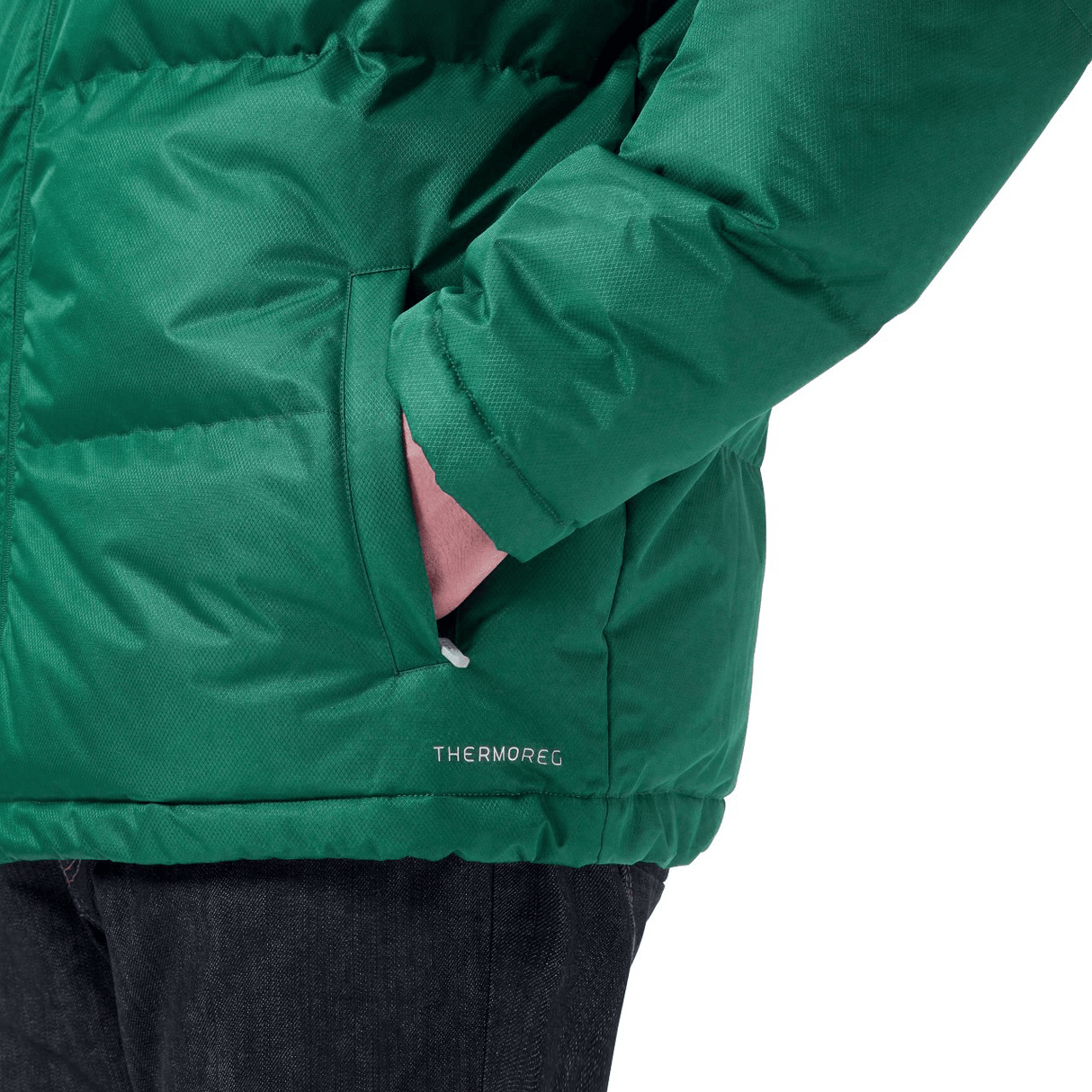 Close-up of someone wearing the Ireland 24 Puffer Jacket by Canterbury with "THERMOREG" text, their left hand in the pocket. The person, also in dark jeans, showcases this Just In piece perfectly for those chilly Canterbury days.
