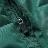 Close-up of a black zipper with a textured pull tab on green ripstop fabric, highlighting detailed stitching and fabric pattern—showcasing the premium craftsmanship of the Ireland 26 Puffer Jacket by Canterbury.