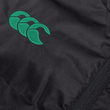 Close-up of a black textured fabric with a green stitched logo featuring three interlocking crescents. A visible zipper lies along the right edge of the Ireland 24 Padded Gilet by Canterbury, enhanced by Vaposhield coating for added durability.