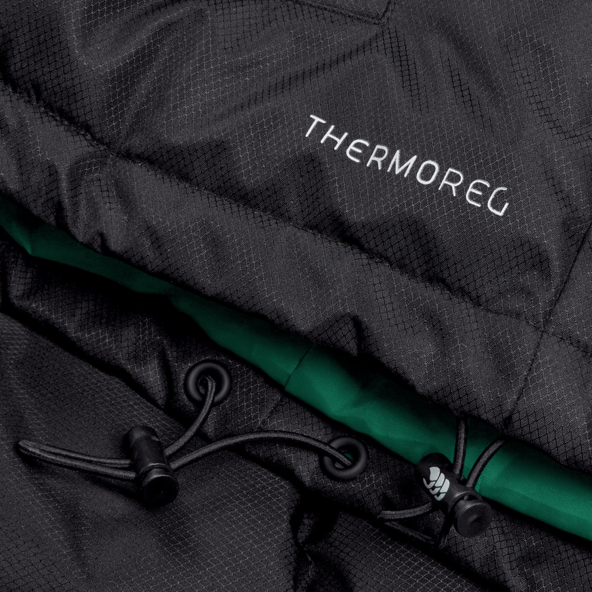 Close-up of a black Ireland 24 Padded Gilet by Canterbury featuring a green inner lining, Vaposhield coating, and adjustable cords visible.