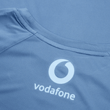 Close-up of the back of a blue Ireland 24 Superlight Training T-Shirt by Canterbury featuring the Vodafone logo in white, often seen on Ireland's athletic wear.