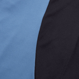 Close-up of a fabric with two distinct sections: a smooth, light blue fabric on the left resembling an Ireland 24 Superlight Training T-Shirt by Canterbury, and a textured black fabric on the right.