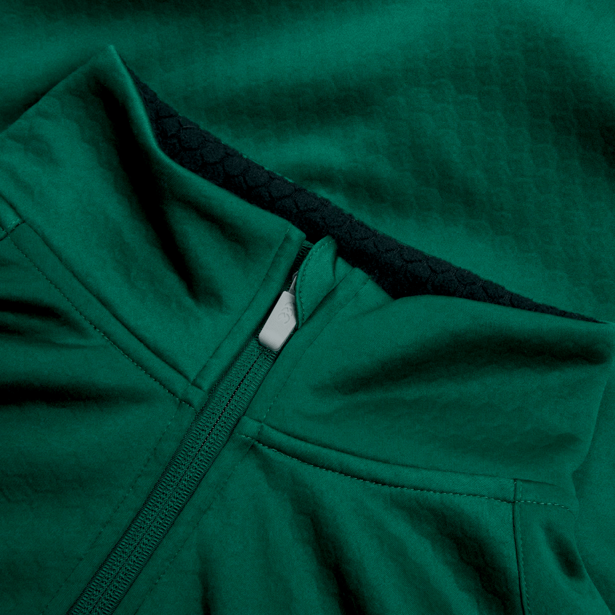 Close-up of the Ireland 1/4 Zip Training Top 24 by Canterbury in green, highlighting its front zipper and textured fabric pattern.