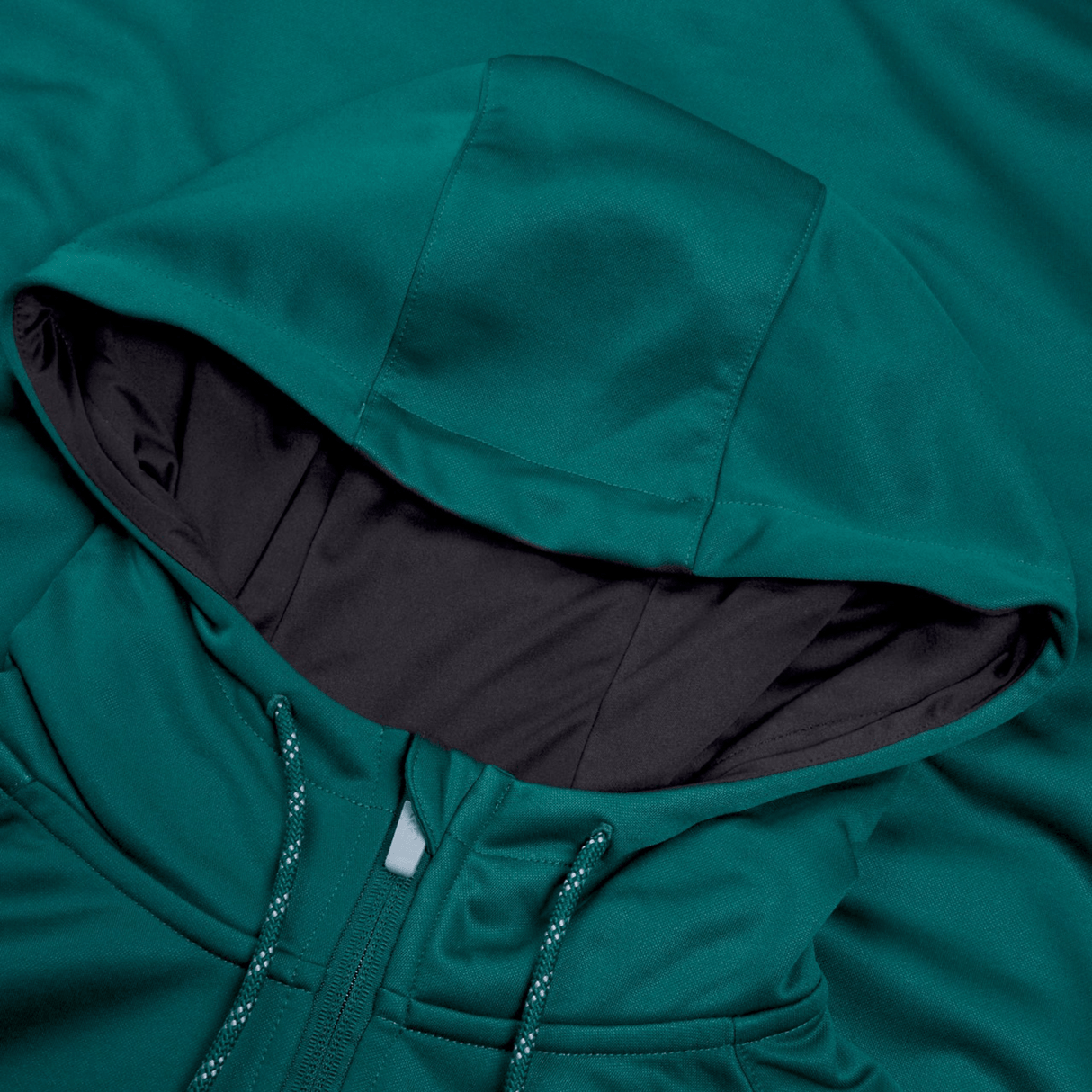 Close-up of a Canterbury Ireland Training Hoodie 24 in teal fabric with a drawstring hood. The interior of the hood is lined with dark fabric, highlighting the texture and color detail of the 100% polyester material.