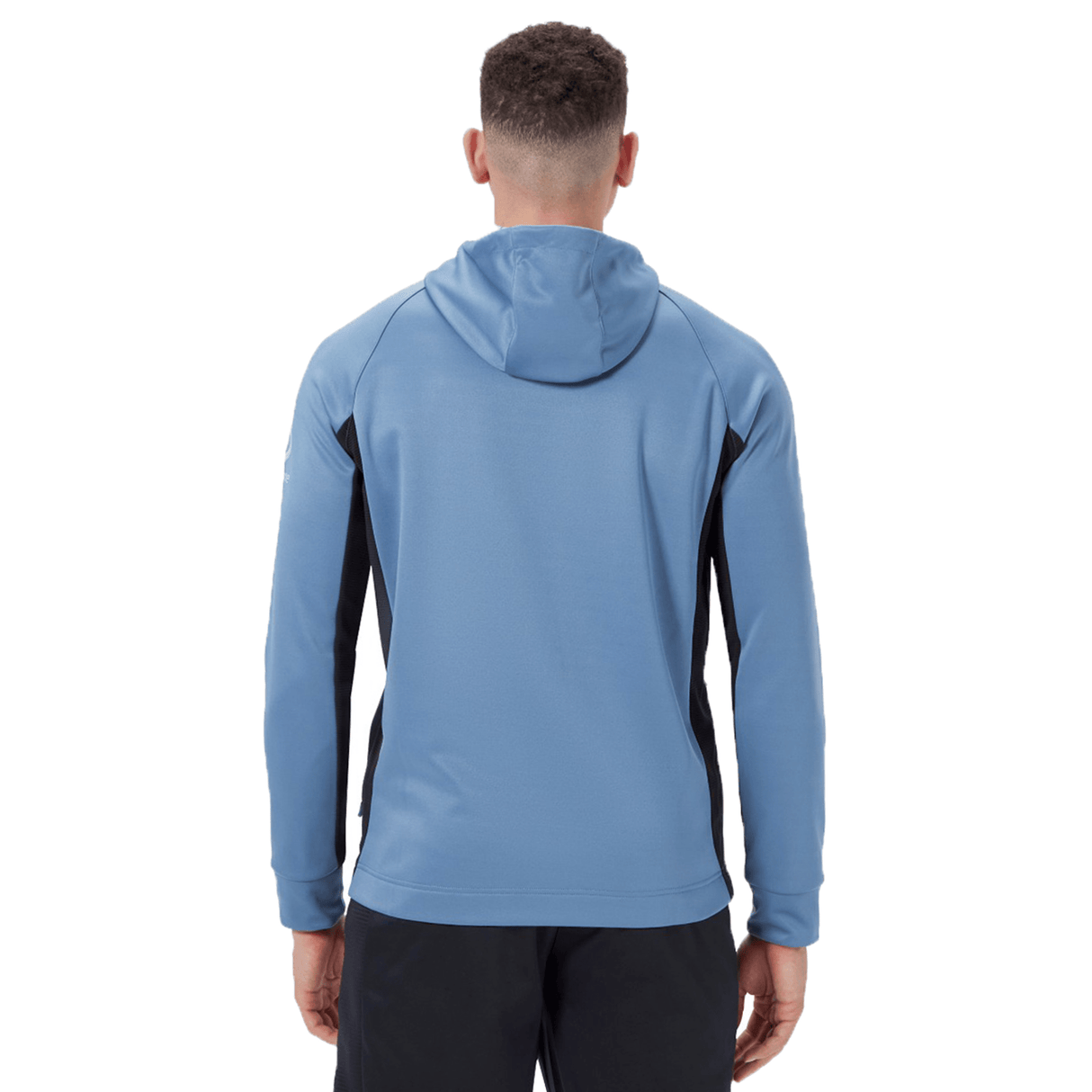 A person wearing a blue Ireland Training Hoodie 24 by Canterbury is seen from the back. The hoodie, made from durable polyester, showcases black side panels. The person is also sporting black pants.
