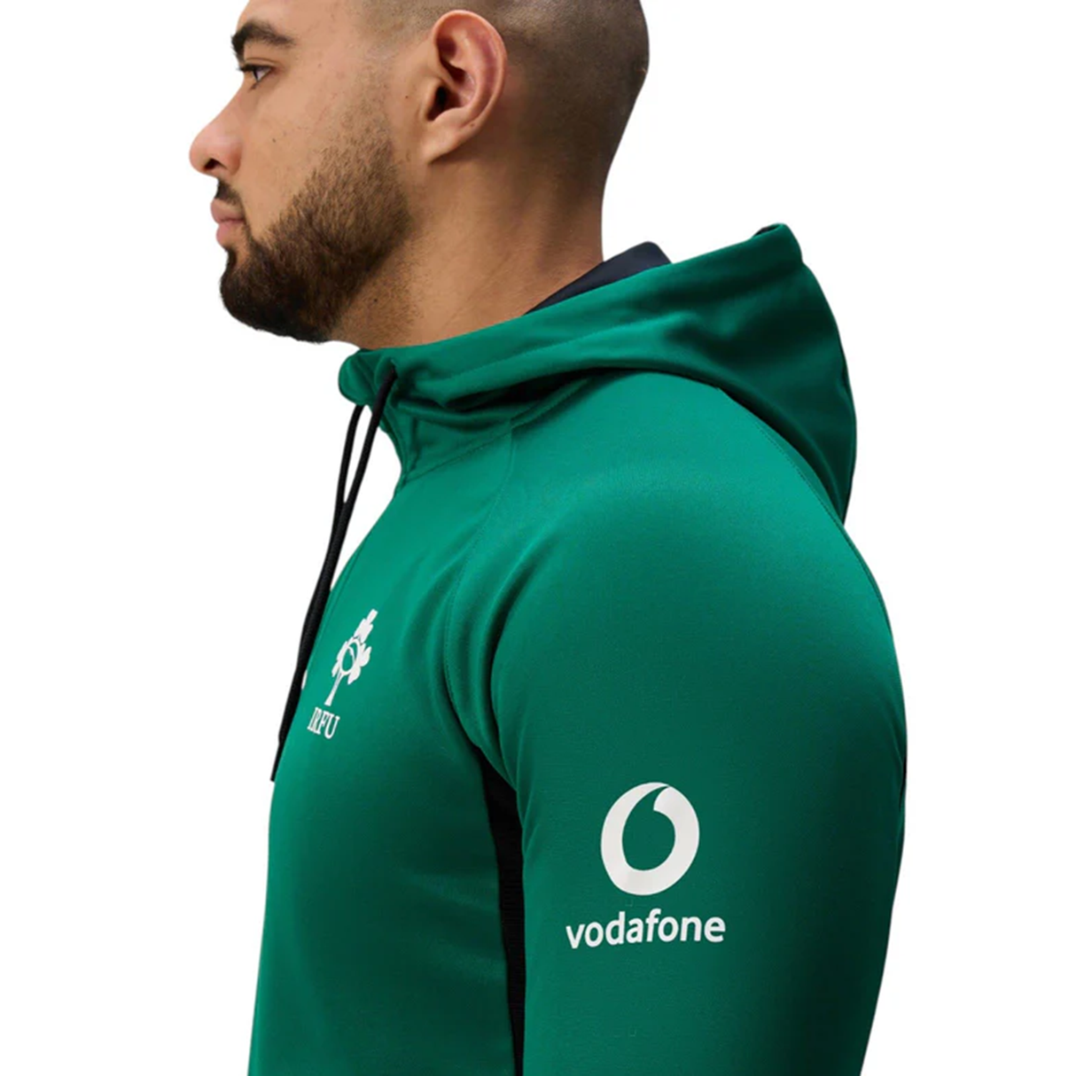 A man in profile wears the Ireland 25/26 Training Hoodie by Canterbury, featuring the IRFU crest on the chest and a Vodafone logo on the sleeve—a classic piece for true rugby fans.