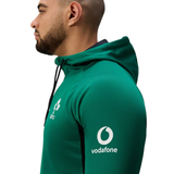 A man in profile wears the Ireland 25/26 Training Hoodie by Canterbury, featuring the IRFU crest on the chest and a Vodafone logo on the sleeve—a classic piece for true rugby fans.