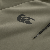 Close-up of the Ireland 25/26 Training Hoodie by Canterbury in olive green, featuring a black triple-wave logo above a horizontal zippered pocket.