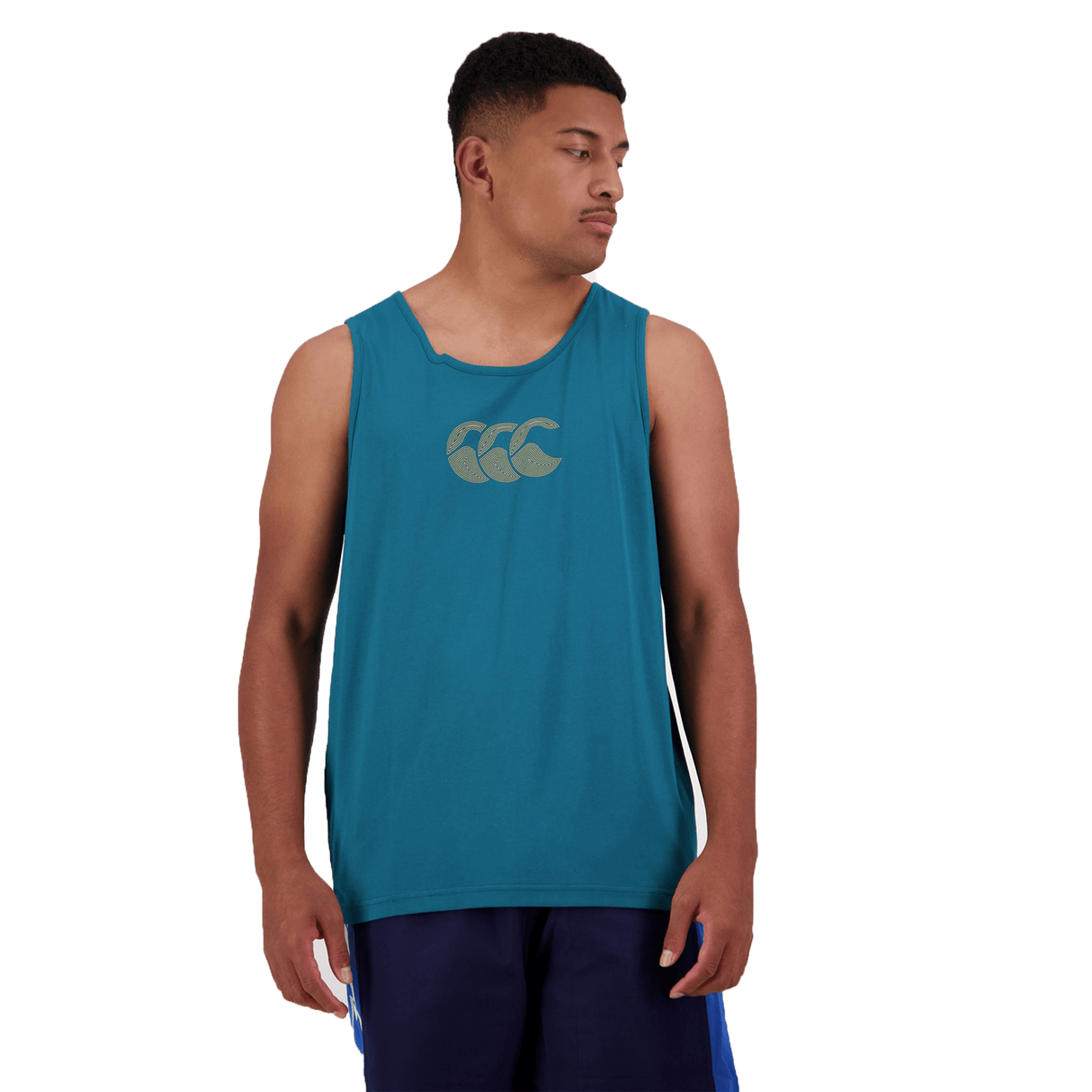 A person wearing the Canterbury Radial CCC Logo Singlet in teal gazes to the side against a pristine white background.
