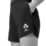 A person wearing Canterbury Women's Ireland 25/26 Woven Gym Shorts with a hand in the pocket, shown from waist to mid-thigh—ideal for Ireland women's rugby or as comfortable Canterbury gym shorts.
