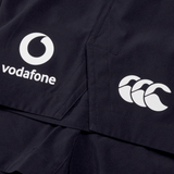 Close-up of the dark-colored Ireland 24 Woven Gym Short by Canterbury featuring white logos of Vodafone and Canterbury.