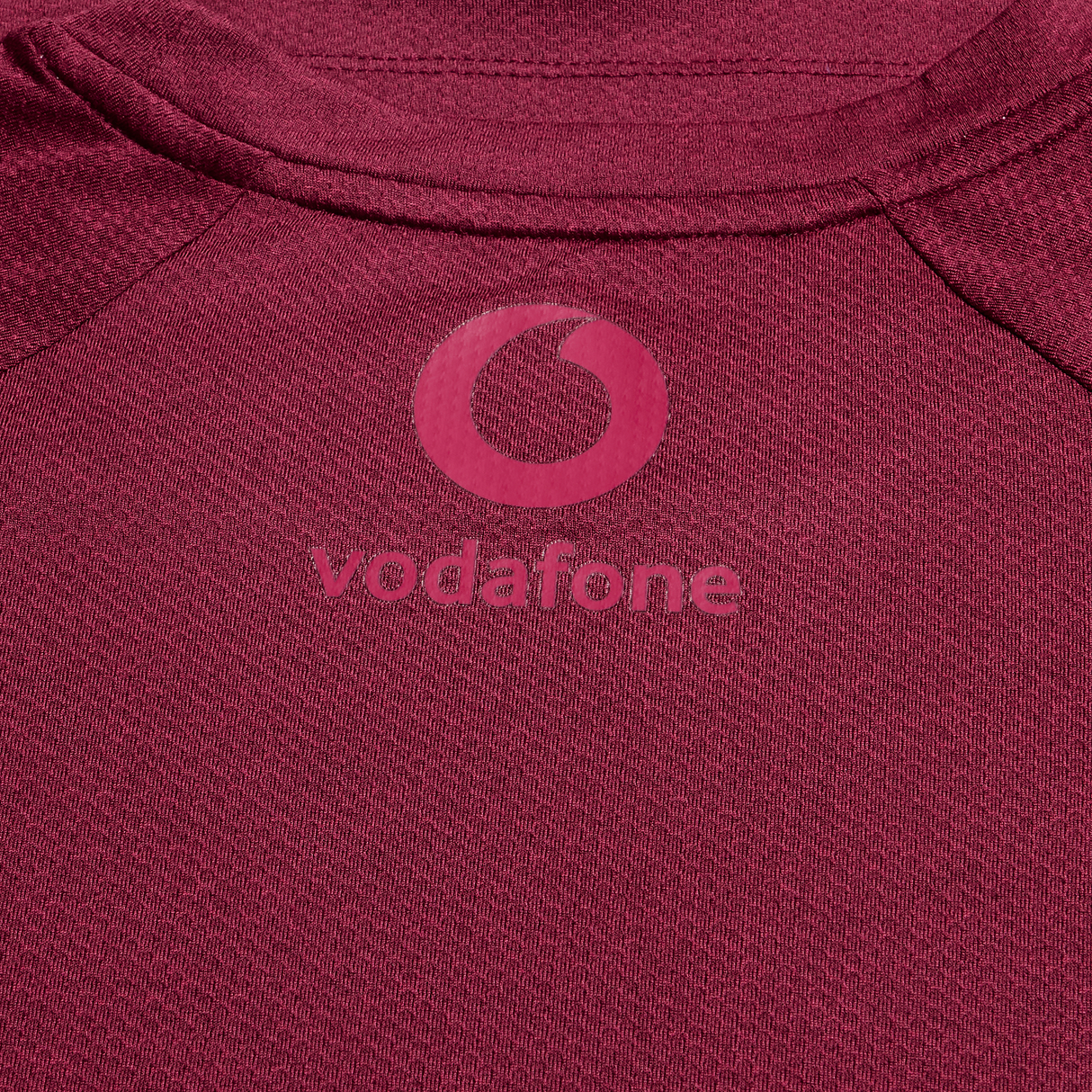 Close-up of the Canterbury Ireland 25/26 Autumn Internationals Elite Training Tee, showcasing the maroon Vapodri fabric and pink Vodafone logo.