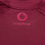 Close-up of the Canterbury Ireland 25/26 Autumn Internationals Elite Training Tee, showcasing the maroon Vapodri fabric and pink Vodafone logo.